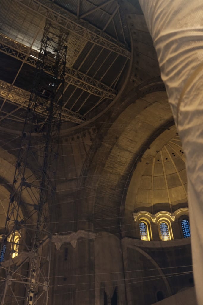 Inside of Saint Sava – there is a guy riding an elevator down in the middle scaffolding tower